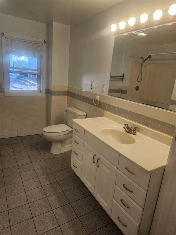233-235 Main Street Everett, MA 02149 - Photo 13 of 20 a bathroom with a sink a toilet and mirror