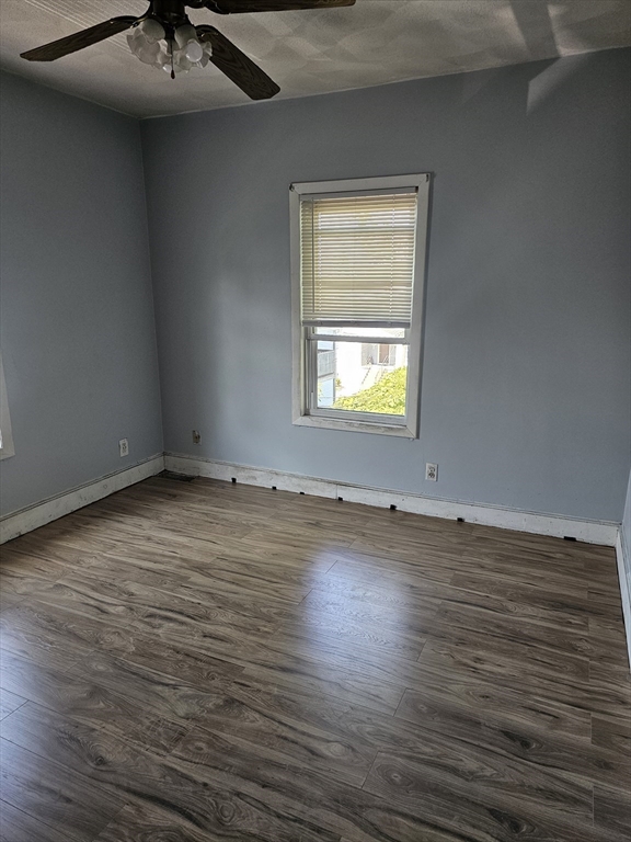 233-235 Main Street Everett, MA 02149 - Photo 14 of 20 an empty room with wooden floor and a sink