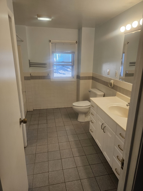 233-235 Main Street Everett, MA 02149 - Photo 15 of 20 a bathroom with a sink a toilet and a mirror