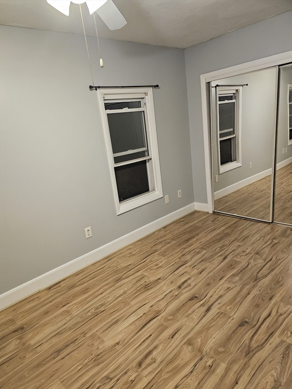 233-235 Main Street Everett, MA 02149 - Photo 17 of 20 a view of empty room with wooden floor and fan