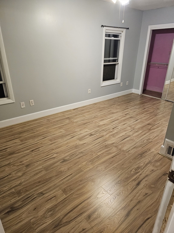 233-235 Main Street Everett, MA 02149 - Photo 18 of 20 a view of an empty room with wooden floor and a window