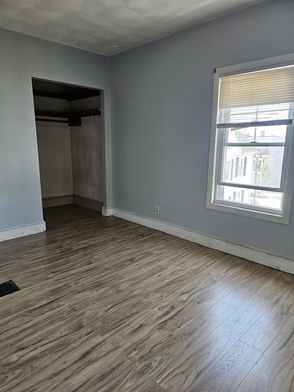 233-235 Main Street Everett, MA 02149 - Photo 20 of 20 a view of an empty room with wooden floor and a window