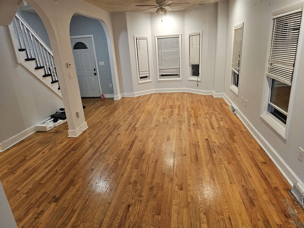 233-235 Main Street Everett, MA 02149 - Photo 8 of 20 a view of empty room with wooden floor and fan