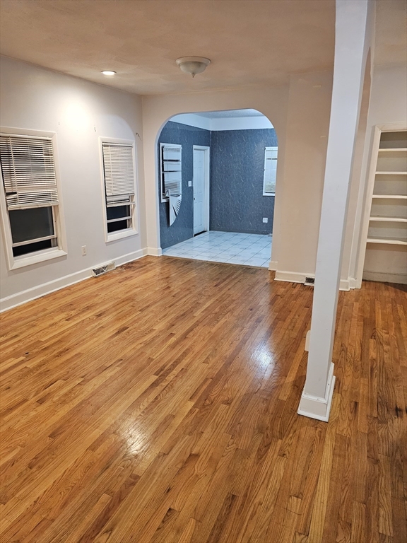 233-235 Main Street Everett, MA 02149 - Photo 10 of 20 a view of an empty room with wooden floor and a window