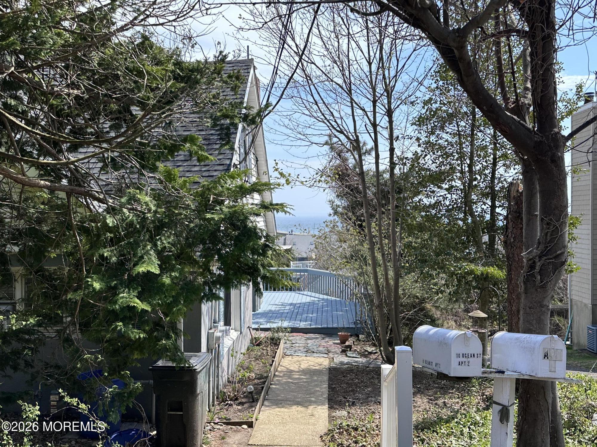 10 Ocean Street Highlands, NJ 07732 - Photo 13 of 15 a front view of a house with garden and trees