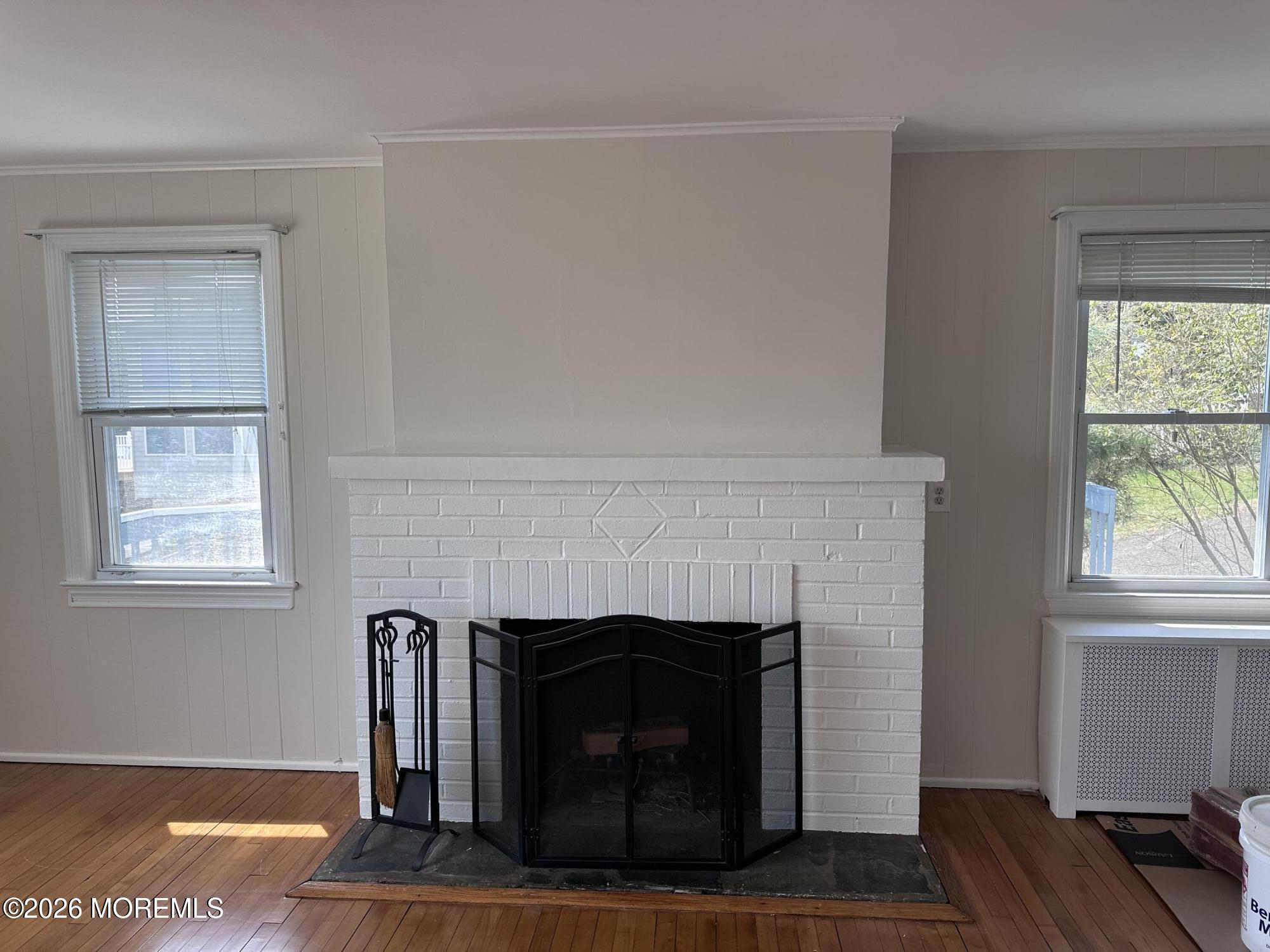 10 Ocean Street Highlands, NJ 07732 - Photo 4 of 15 a living room with a fireplace and a table