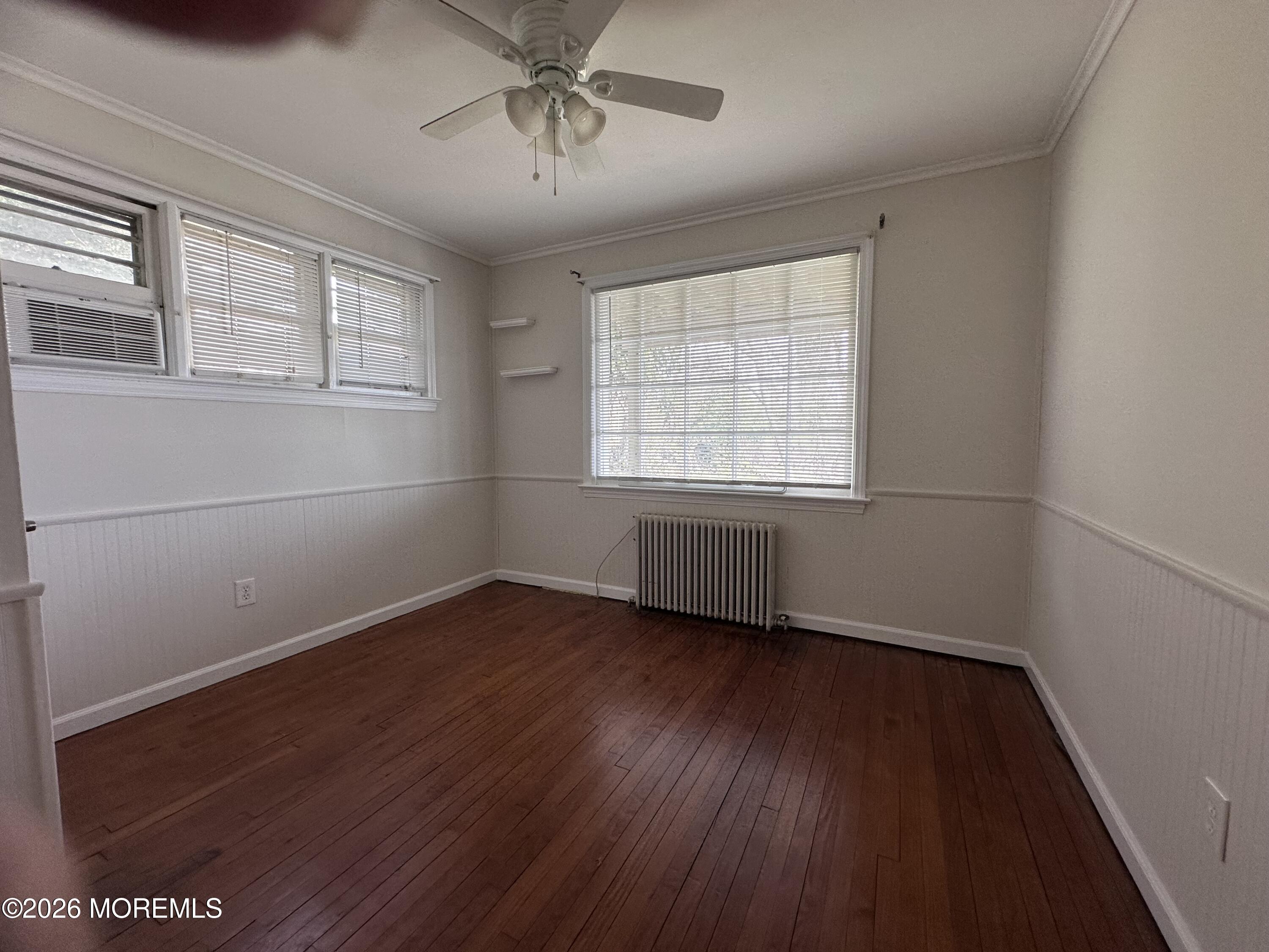 10 Ocean Street Highlands, NJ 07732 - Photo 8 of 15 a view of an empty room with wooden floor and a window