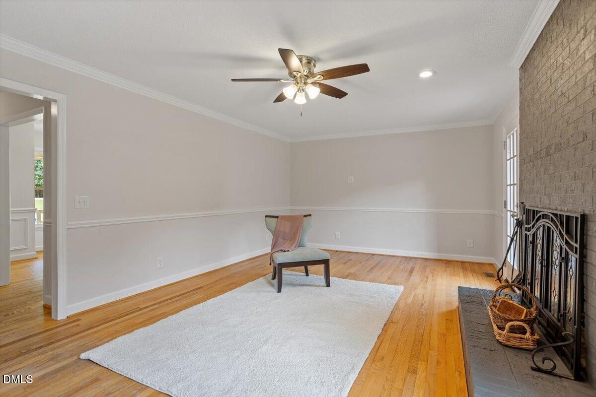 805 Rand Road Garner, NC 27529 - Photo 17 of 38 a hallway with a bed and a chandelier