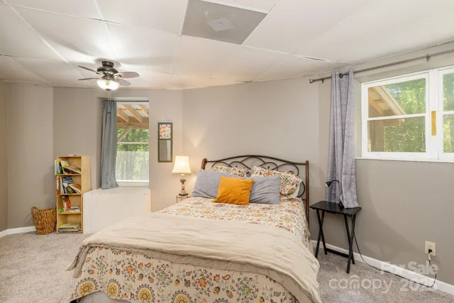 a bedroom with a large bed and a window