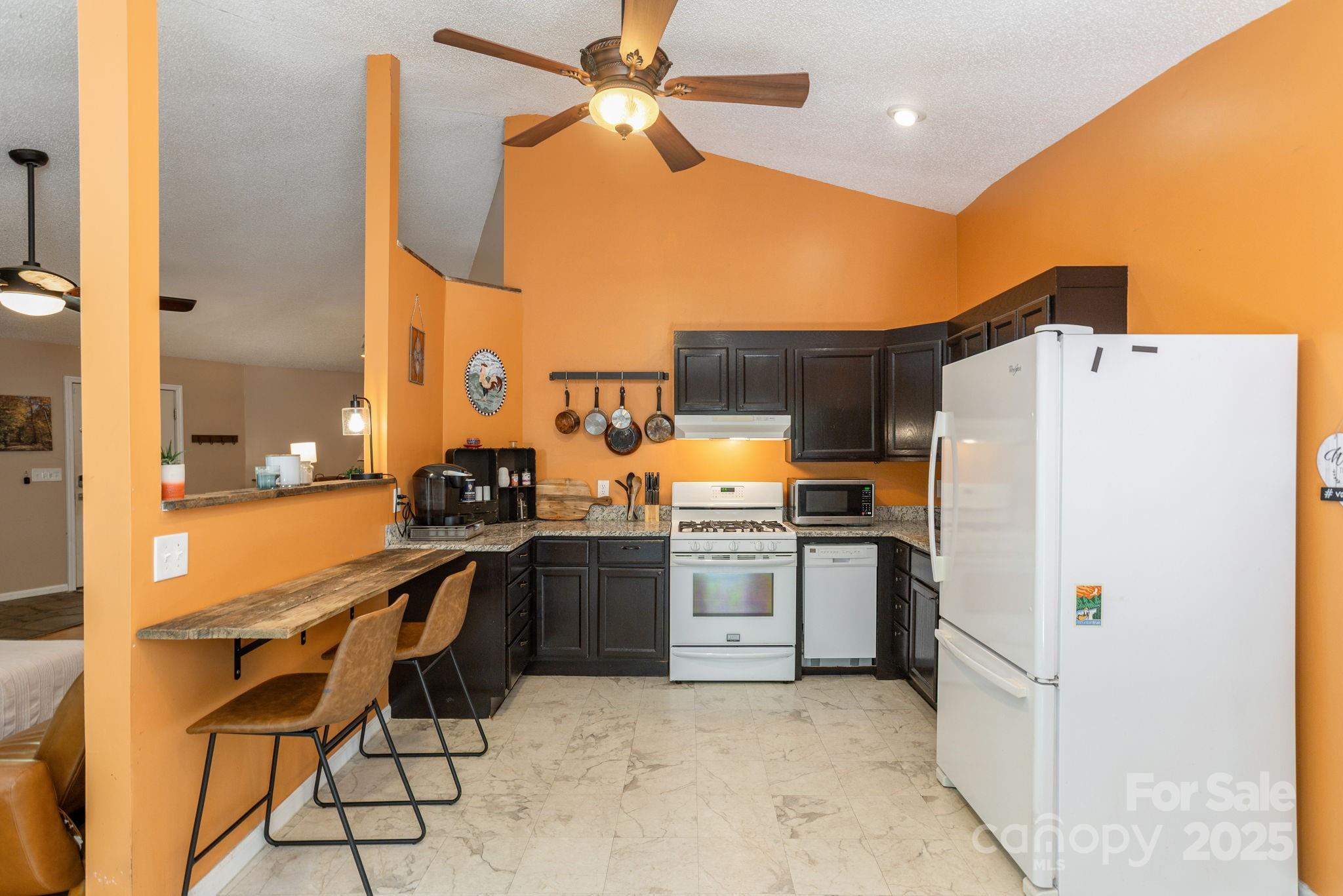 78 Bryant Road Swannanoa, NC 28778 - Photo 7 of 29 a kitchen with a refrigerator and a stove