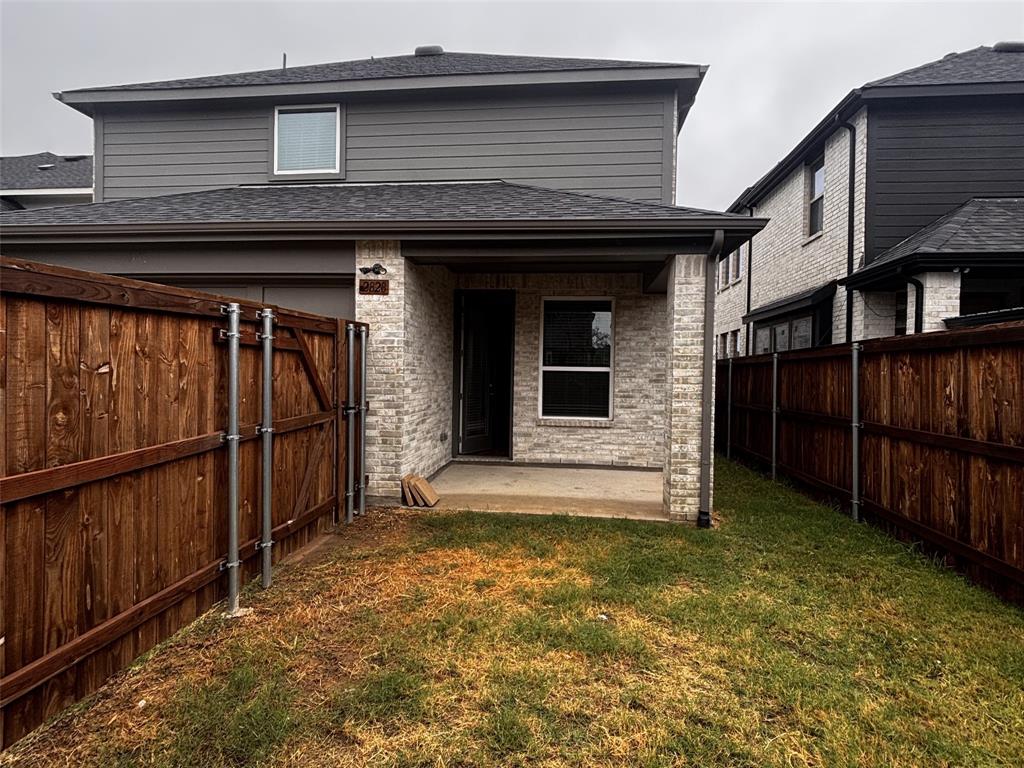 2828 Walden Road Celina, TX 75009 - Photo 28 of 30 Rear exterior with brick siding, a covered patio, and a privacy fence