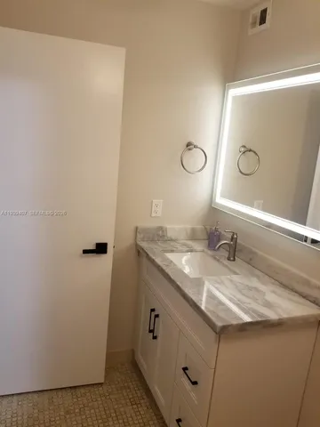 a bathroom with a sink a toilet and mirror