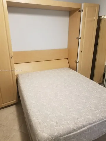 a living room with furniture and a dining table