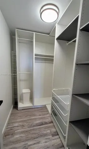 a living room with furniture potted plant and a chandelier