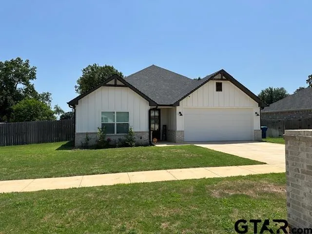 a view of a house with a yard and garage