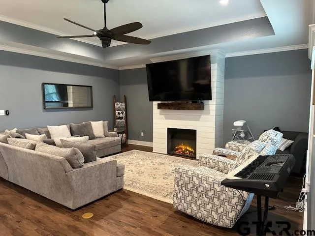 a living room with furniture a flat screen tv and a fireplace