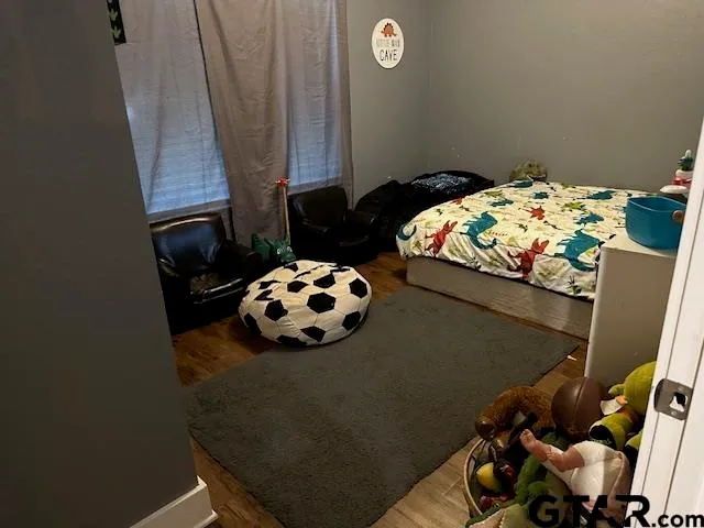 a bed sitting in a bedroom next to a window