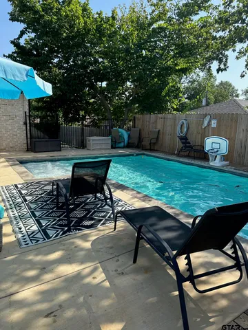 a view of a backyard with sitting area