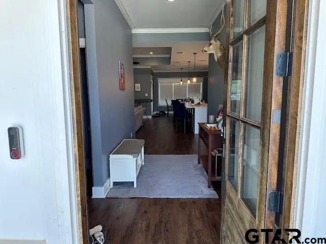 a view of hallway with furniture and a window