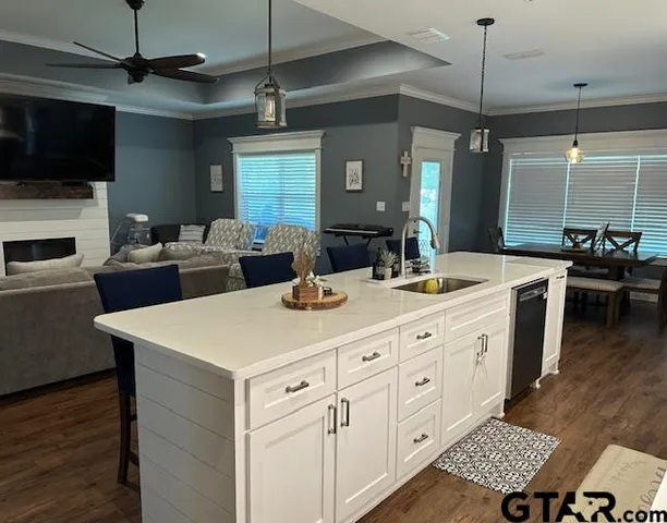 a large kitchen with a table chairs and a refrigerator