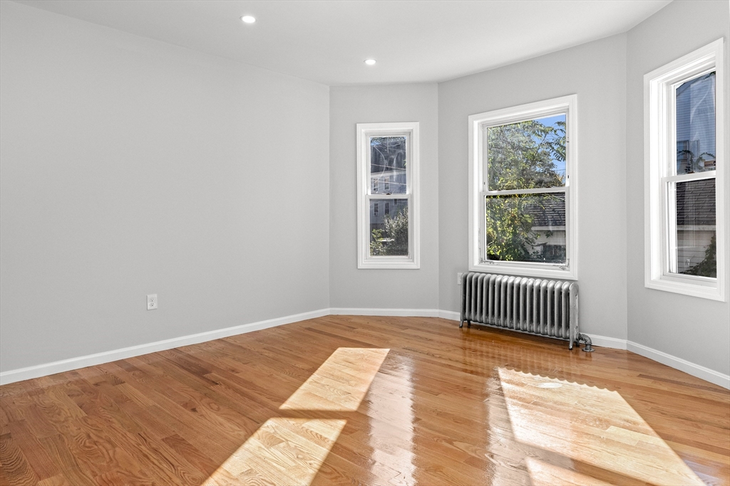68 Middlebury Street Lawrence, MA 01841 - Photo 15 of 41 a view of empty room with wooden floor and fan