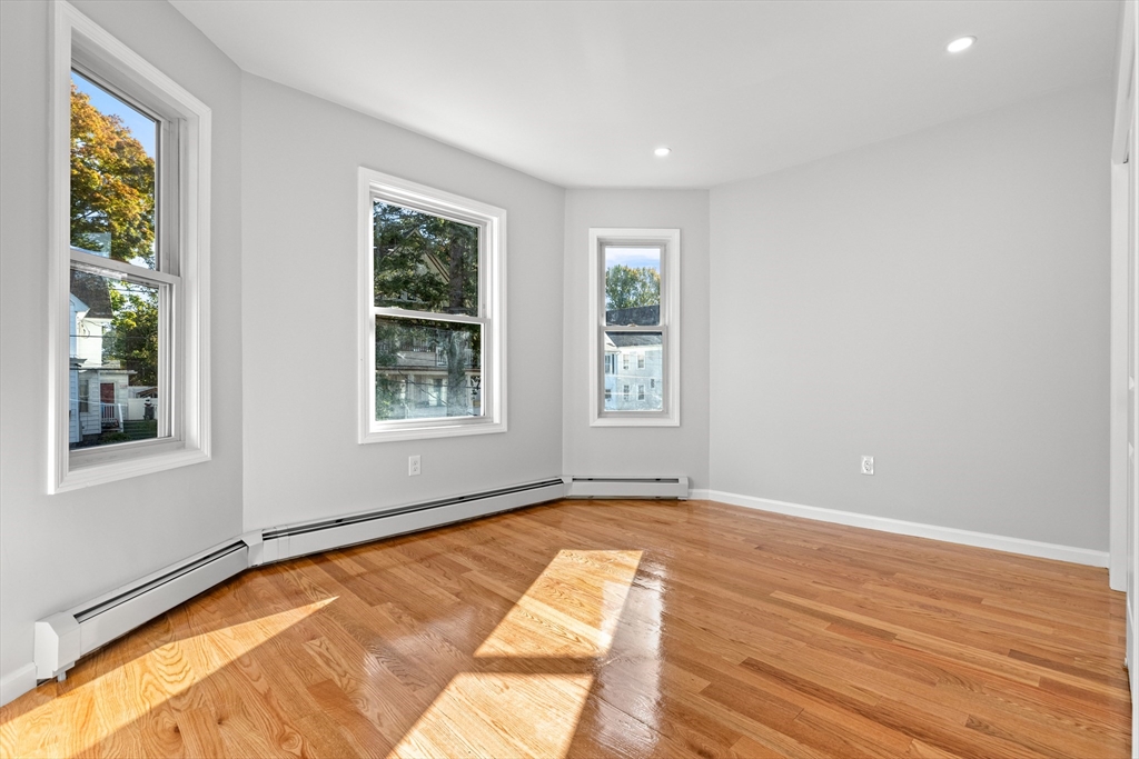 68 Middlebury Street Lawrence, MA 01841 - Photo 19 of 41 a view of an empty room with wooden floor and a window