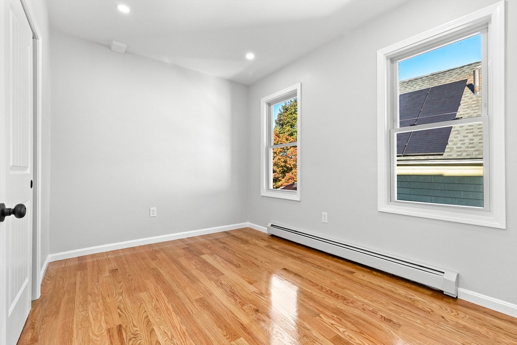 68 Middlebury Street Lawrence, MA 01841 - Photo 21 of 41 a view of empty room with window and wooden floor