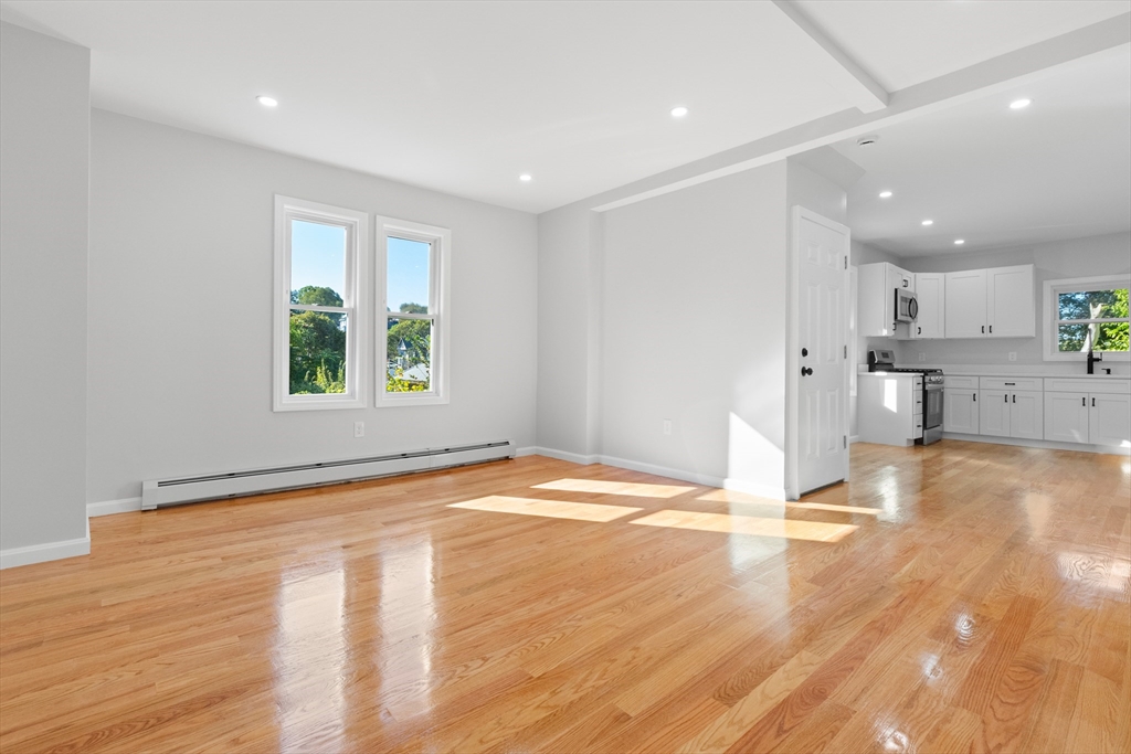 68 Middlebury Street Lawrence, MA 01841 - Photo 23 of 41 a view of empty room with wooden floor and windows