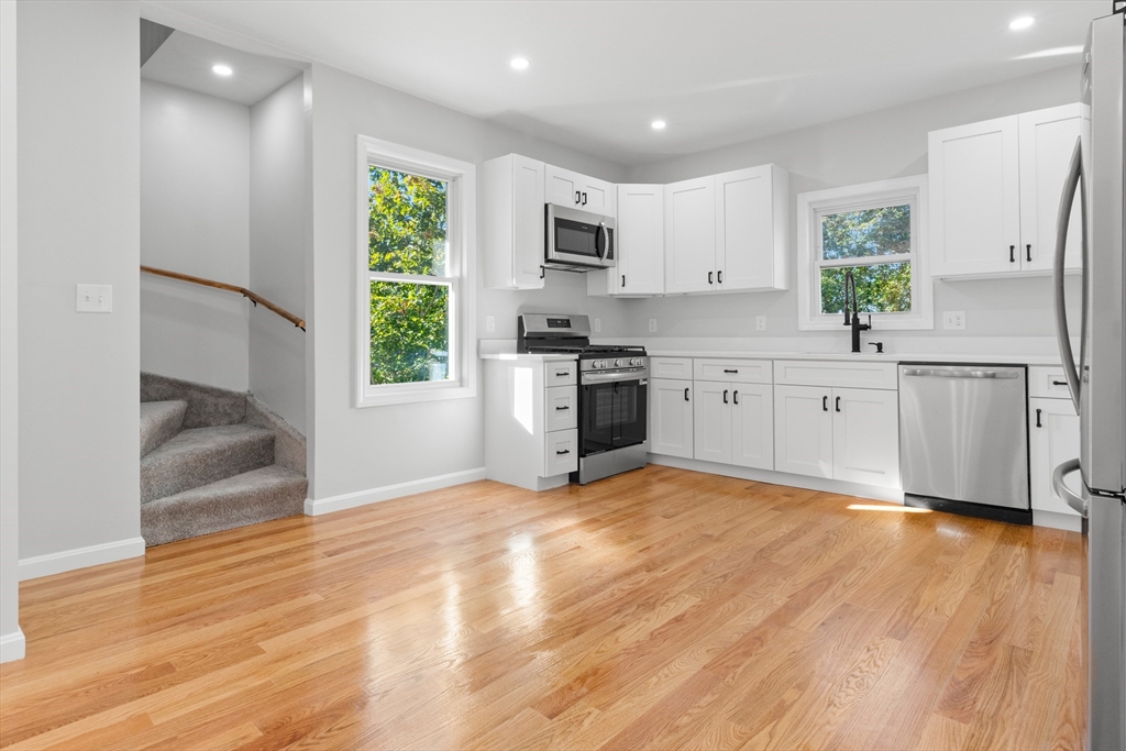 68 Middlebury Street Lawrence, MA 01841 - Photo 26 of 41 a large kitchen with stainless steel appliances granite countertop a stove a sink and a refrigerator