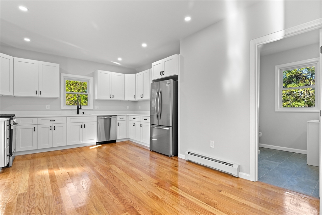 68 Middlebury Street Lawrence, MA 01841 - Photo 28 of 41 a kitchen with stainless steel appliances a refrigerator and a stove top oven