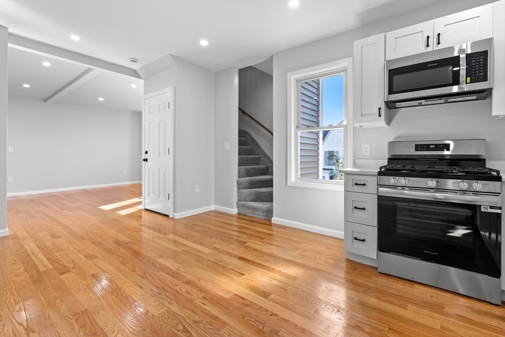 68 Middlebury Street Lawrence, MA 01841 - Photo 29 of 41 a kitchen with granite countertop a stove and a microwave