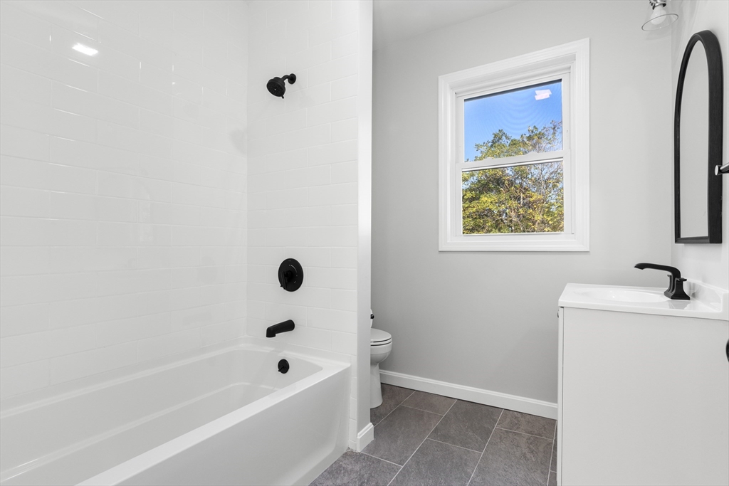 68 Middlebury Street Lawrence, MA 01841 - Photo 30 of 41 a bathroom with a tub a sink a window and a shower