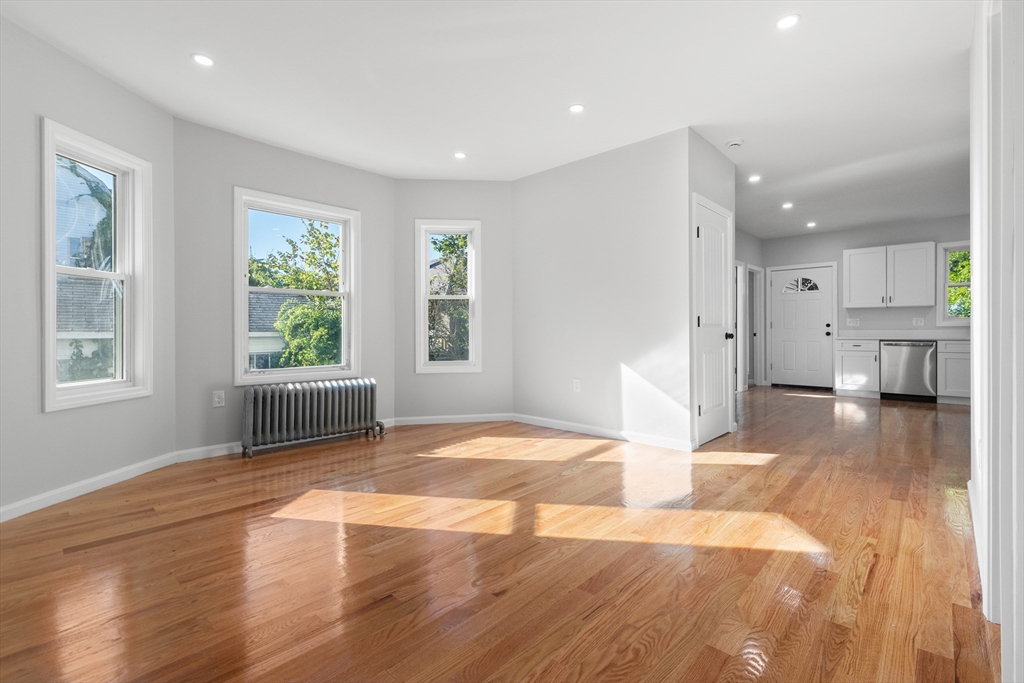 68 Middlebury Street Lawrence, MA 01841 - Photo 3 of 41 a view of empty room with wooden floor and windows