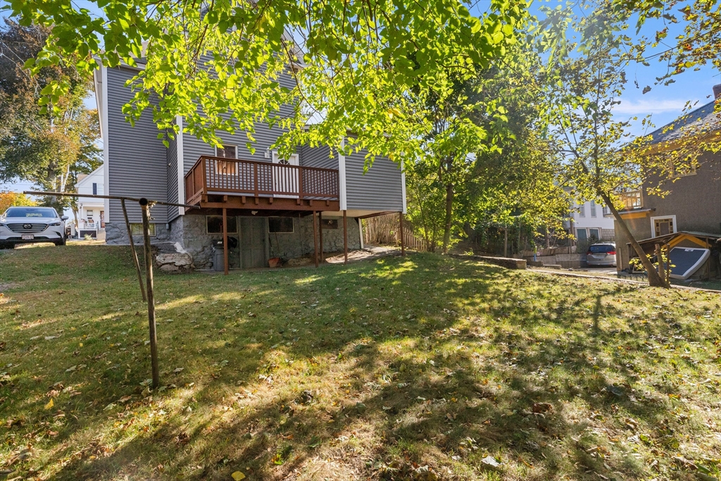 68 Middlebury Street Lawrence, MA 01841 - Photo 39 of 41 a backyard of a house with barbeque oven table and chairs