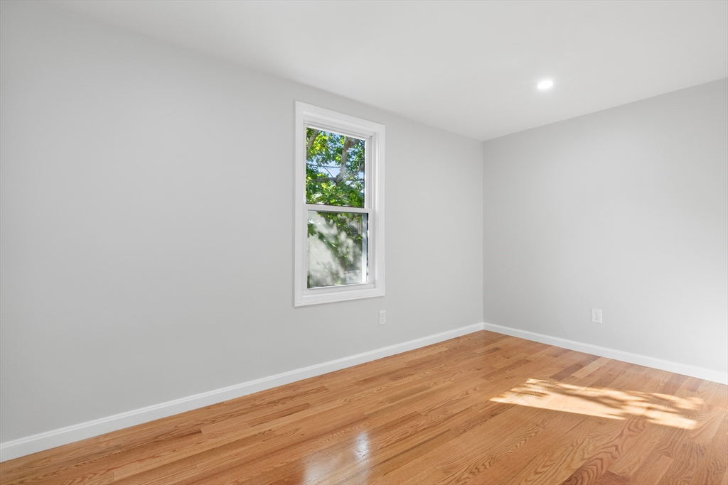 68 Middlebury Street Lawrence, MA 01841 - Photo 9 of 41 wooden floor in an empty room with a window