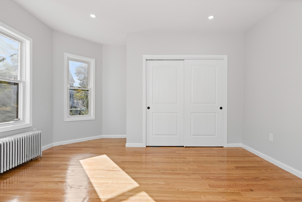 68 Middlebury Street Lawrence, MA 01841 - Photo 10 of 41 a view of an empty room with wooden floor and a window