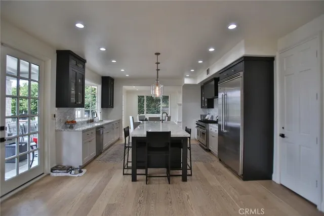 a kitchen with a table chairs refrigerator and cabinets
