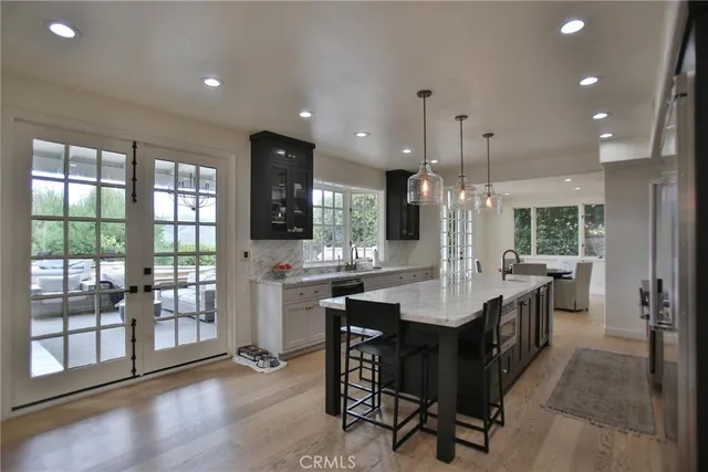 a large kitchen with a table and chairs