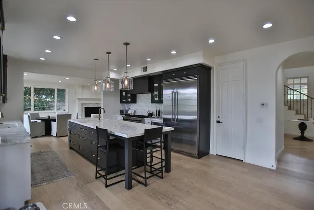 a large kitchen with kitchen island a sink stainless steel appliances and cabinets