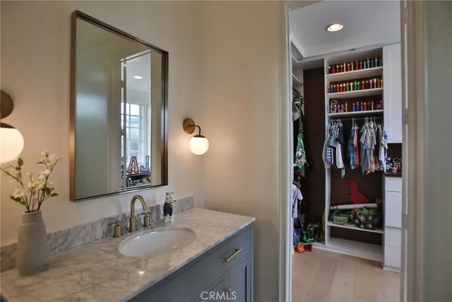 a living room with furniture a flat screen tv and a bookshelf
