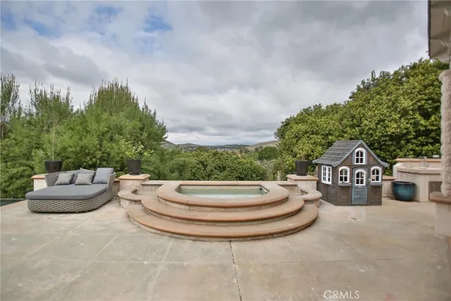a view of a house with swimming pool and sitting area