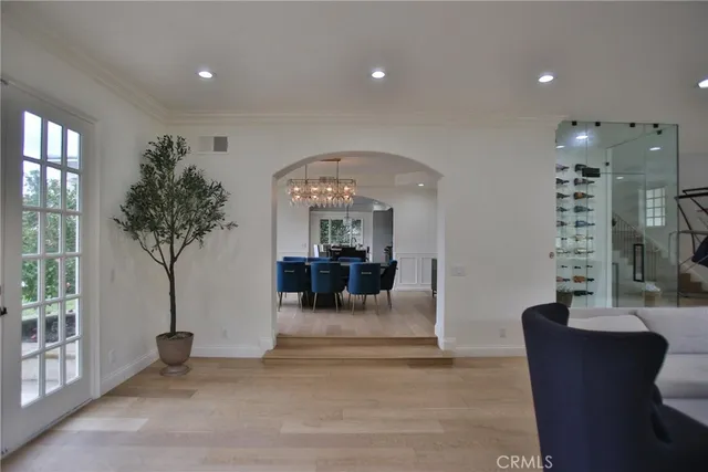 a living room with furniture a potted plant and a large window