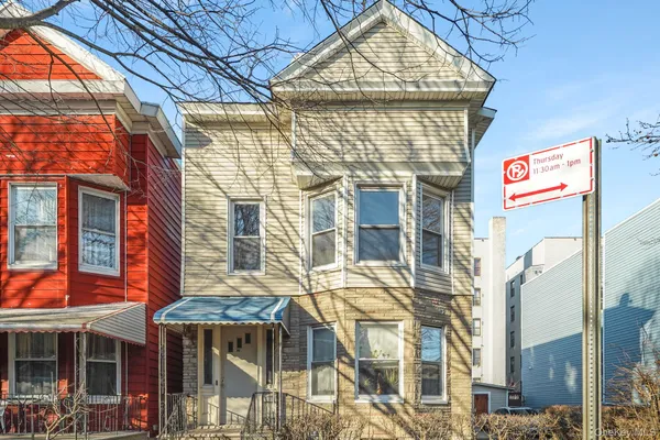 a front view of a residential apartment building with a glass windows