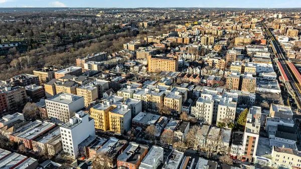 a aerial view of a residential apartment building with a yard