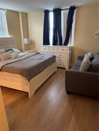 a bedroom with a bed and a couch