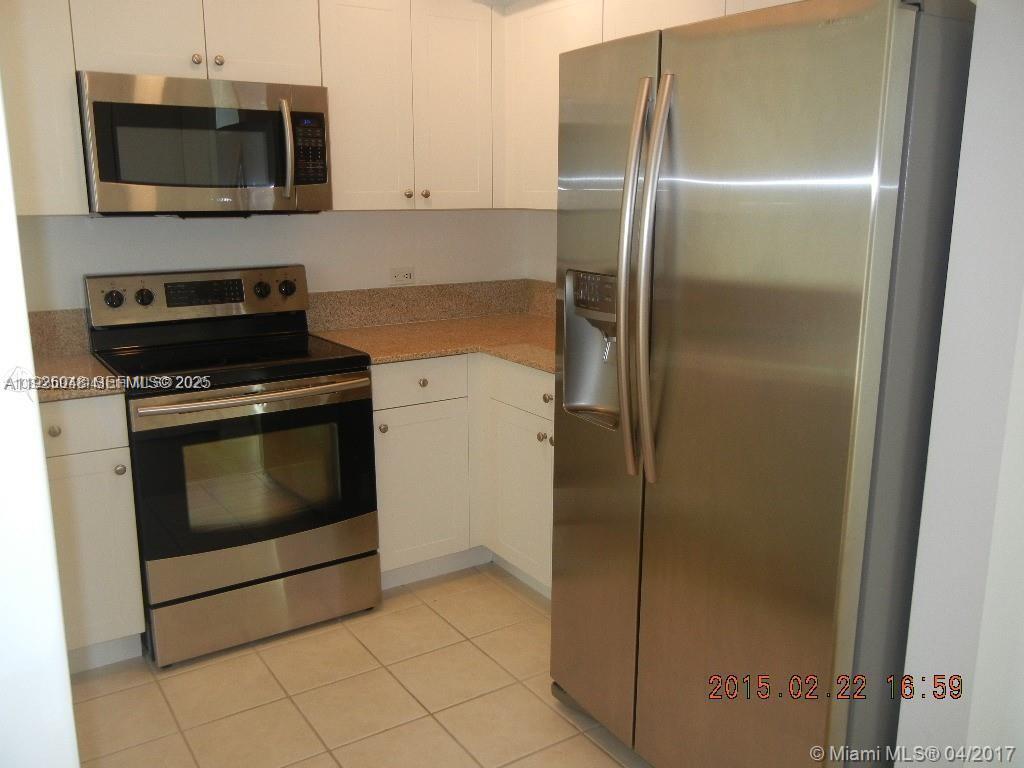 117 Northwest 42nd Avenue, Unit 800 Miami, FL 33126 - Photo 5 of 13 a kitchen with stainless steel appliances granite countertop a refrigerator and a microwave