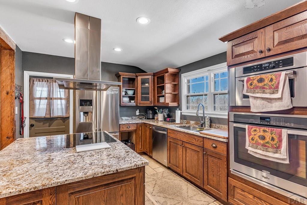 6597 County Lane 14 Ordway, CO 81063 - Photo 11 of 66 a kitchen with stainless steel appliances granite countertop a stove a sink and a refrigerator