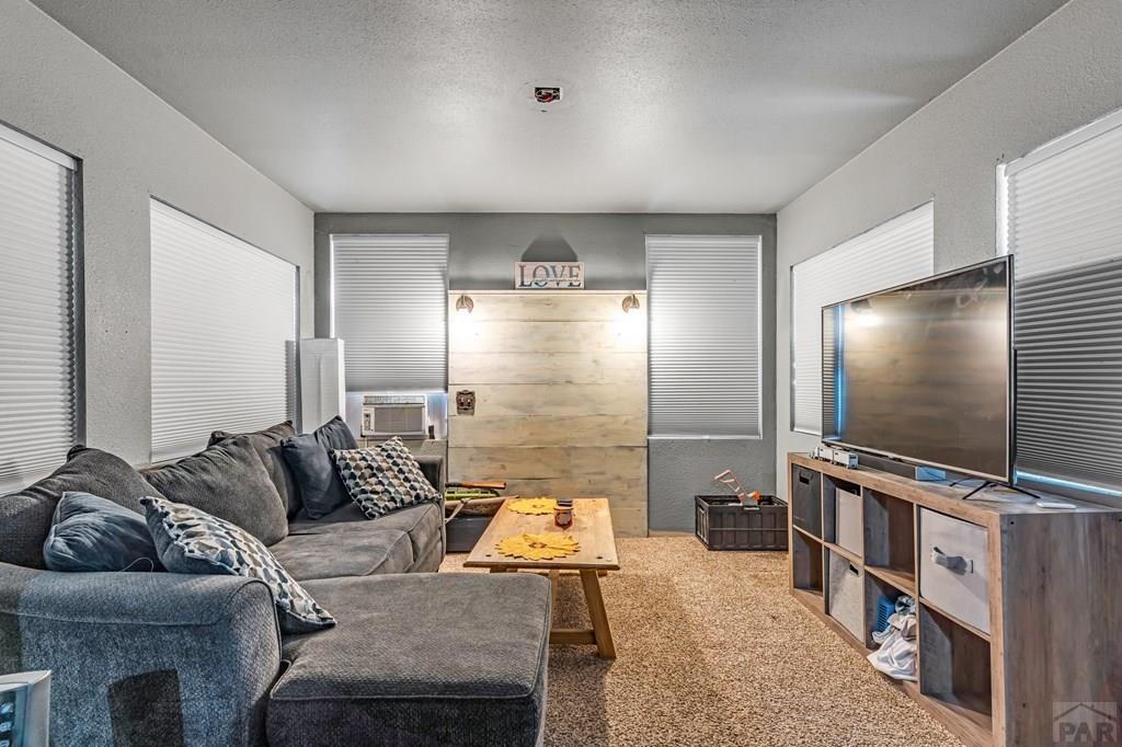 6597 County Lane 14 Ordway, CO 81063 - Photo 20 of 66 a living room with furniture and a flat screen tv