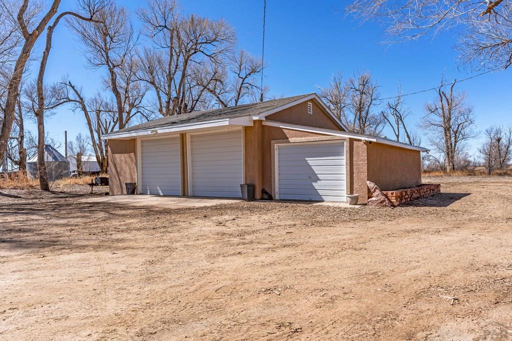 6597 County Lane 14 Ordway, CO 81063 - Photo 27 of 66 a front view of a house with a yard and garage