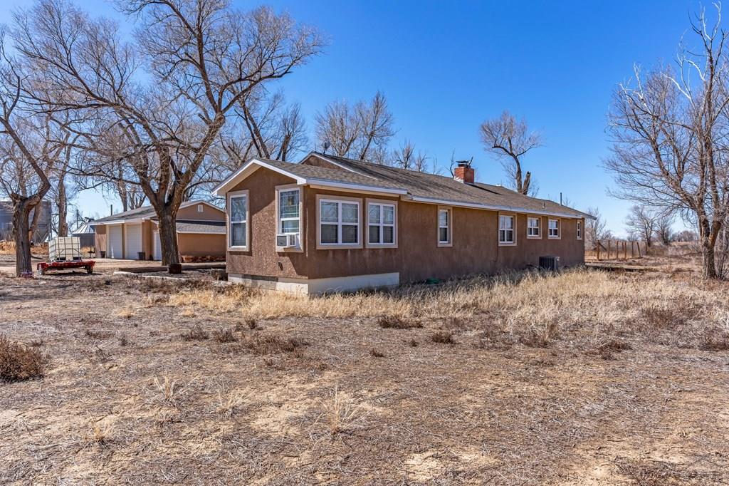 6597 County Lane 14 Ordway, CO 81063 - Photo 7 of 66 a view of a house with a yard covered with snow in the background